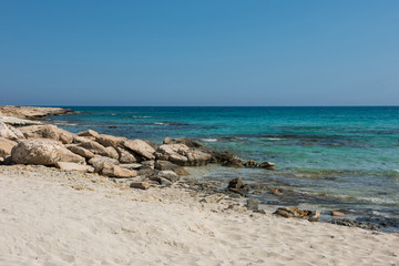 Fototapeta na wymiar Rocky and sandy sea coast in Cyprus