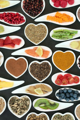 Healthy heart food with fish, fruit, vegetables and herbal medicine selection. Super foods high in omega 3 fatty acids, antioxidants, anthocyanins, vitamins and minerals. 
