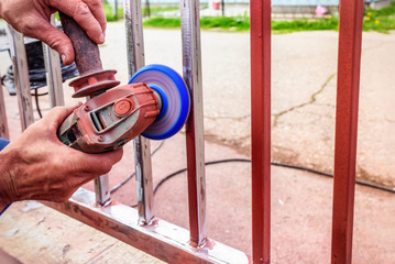 removing paint from iron fence with grinder