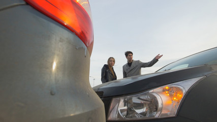 Young woman shouting at man after a car accident