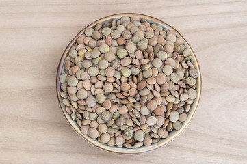 lentils inside a bowl on wooden table