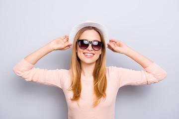 Youth freedom carefree people person concept. Close up portrait of relaxed excited cheerful joyful glad attractive lady with toothy beaming smile correcting fixing white hat isolated gray background