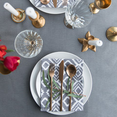 flat lay with beautiful rustic table arrangement with old fashioned tarnished cutlery and wine glasses