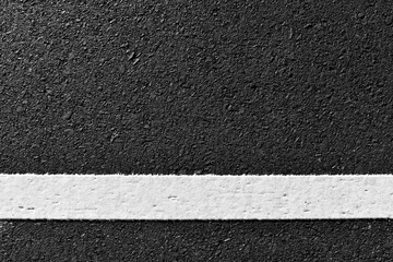 Fototapeta premium dirty white line on surface of old asphalt in countryside