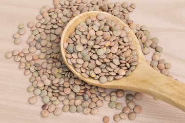 table full of lentils and wooden spoon