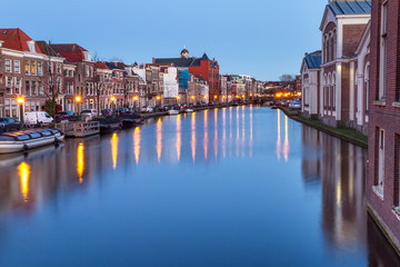 Cityscape - evening view of the city canal with bridge and boats, the city of Leiden, Netherlands