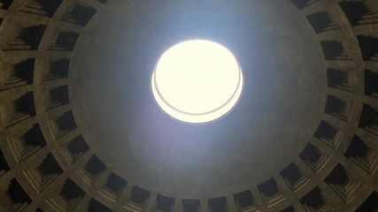 Internal view of the Pantheon in Rome. Detail of the hole in the dome (oculus) through which sunlight passes - Powered by Adobe
