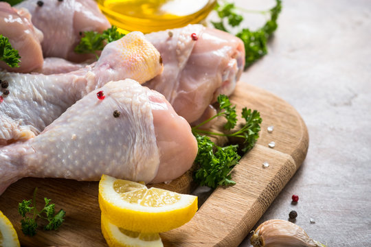 Raw Chicken drumsticks and cooking ingredients. 