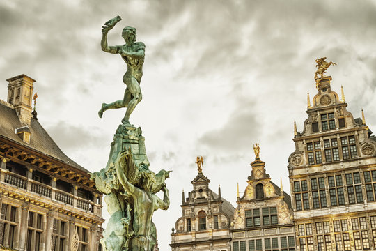 Cityscape - view of the Brabo fountain and a building the Guildhouses decorated with sculpture St. George, the Grote Markt (Main Square) of Antwerp, in Belgium