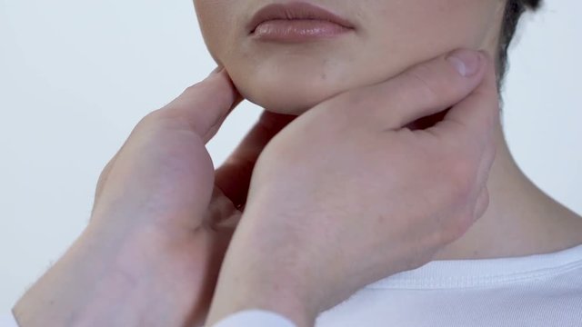 Doctor examining woman lymph nodes, throat infection, patient consultation