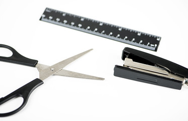 Scissors, ruler measuring and stapler on white background. Stationery. Workplace.