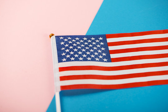 United States of America flag on pink and blue background. Minimalist.