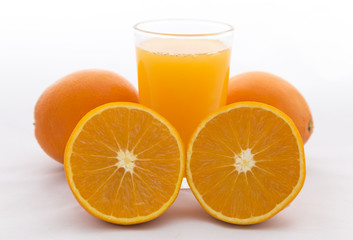 Orange cut on white background and orange juice in glass