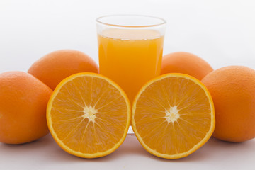 Orange cut on white background and orange juice in glass