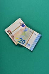 bent banknotes on green background