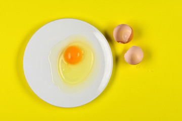 cracked egg on yellow background