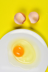 cracked egg on yellow background