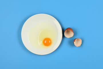 cracked egg on blue background