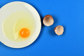 cracked egg on blue background