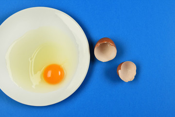 cracked egg on blue background
