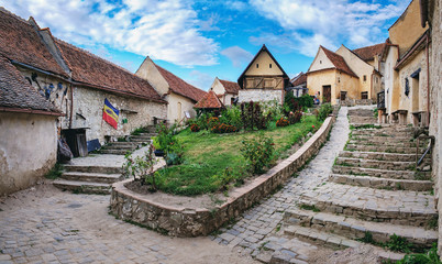 Rasnov Fortress with beautiful medieval stone houses on the main street in Brasov county, Romania....