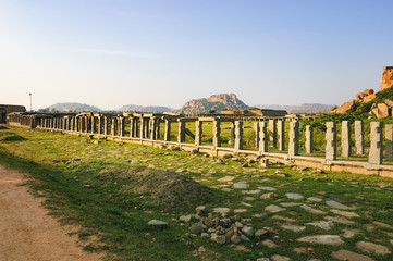 Market complex near temple tank Pushkarani on the way to the Vitthala temple, Hampi, Karnataka, India. Ancient ruins of Vijayanagara Empire. UNESCO World Heritage Site