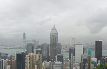 Fototapeta na wymiar Hong Kong: View from Stubbs Road Lookout across Wan Chai to Tsim Sha Tsui with a large construction site on a rainy summer day