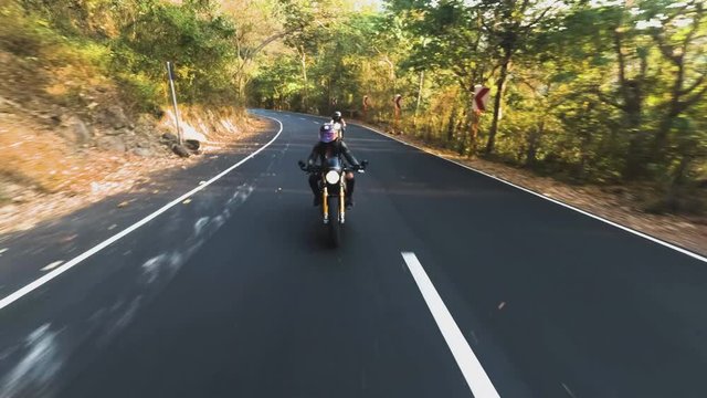 woman riding bike on road near Pico de loro in Philippines