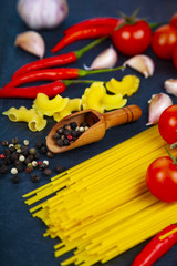 Different pasta on a dark  background.