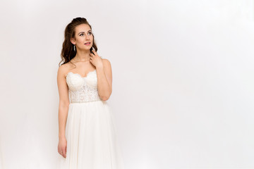 Fototapeta premium beautiful bride in white wedding dress in different poses on white backgrounds shows different emotions