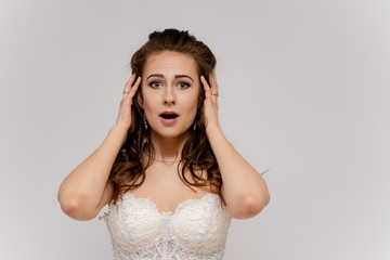 Fototapeta premium beautiful bride in white wedding dress in different poses on white backgrounds shows different emotions
