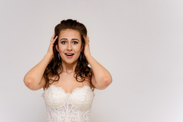 Fototapeta premium beautiful bride in white wedding dress in different poses on white backgrounds shows different emotions