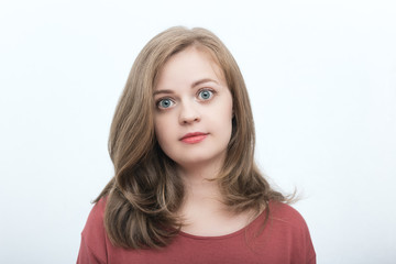 A full face of a blond girl wearing red t-shirt with annoyed, funny, bored, tired or face-palm expression on her face with white background and warm, soft colours