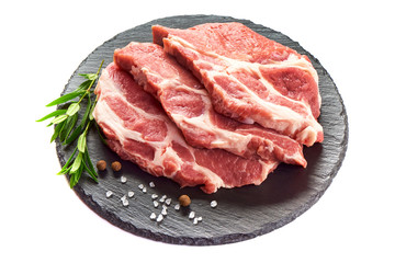 Sliced raw pork meat on stone plate, isolated on white background.