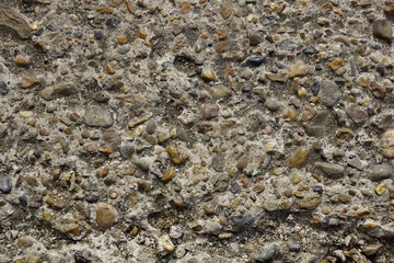 stone and cement texture background. small river stones with cement for sidewalks