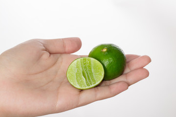 Hand holding lime isolated white background.