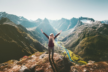 Woman raised arms standing on cliff in mountains landscape Travel healthy Lifestyle getaway trip...