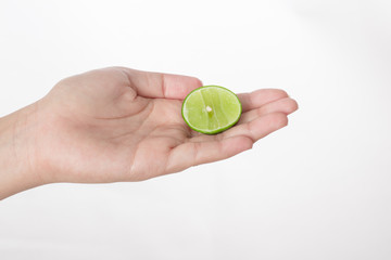 Hand holding lime isolated white background.