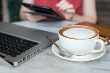 Coffee cup and laptop for business, Selective focus on coffee.