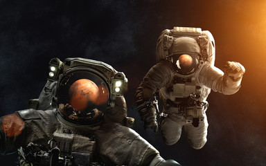 Astronauts in front of Mars. SolarSystem. Image in 5K resolution for desktop wallpaper. Elements of...