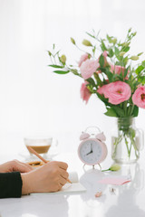 8 am clock. Cookies and flowers on the table.