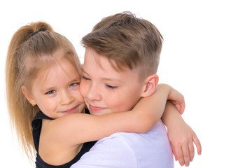 Brother and sister embrace.