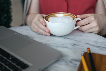 Coffee cup and laptop for business, Selective focus on coffee.