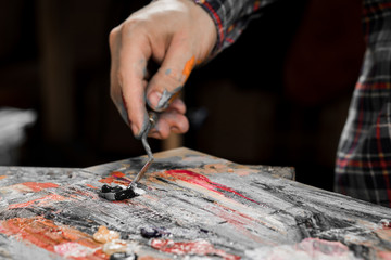 Art painting with palette knife. hand of the artist
