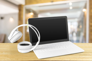 Fototapeta premium Headphones with laptop on table