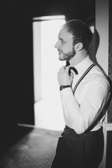 stylish bearded groom posing at the hotel. wedding photo