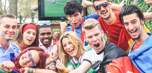 Happy sport fans having fun during football world game
