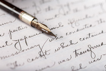 Fountain pen on an antique handwritten letter