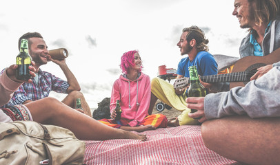 Group of happy friends drinking beers in camping bbq party
