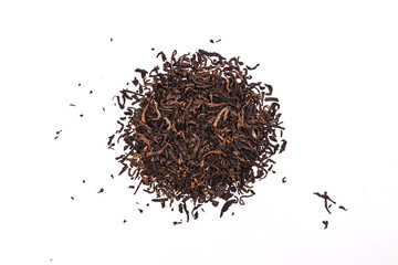 Aromatic black pu-erh tea leaves, a pile of dry red chinese pu-er, close-up, isolated on white